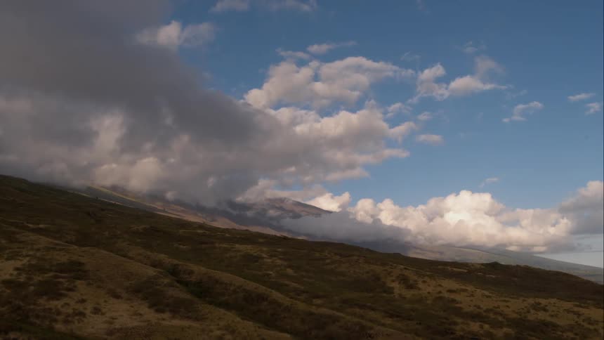 Hills loom before the mountain range