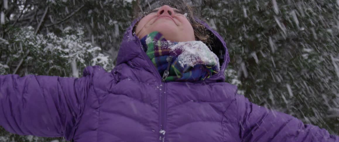 A woman is throwing snow