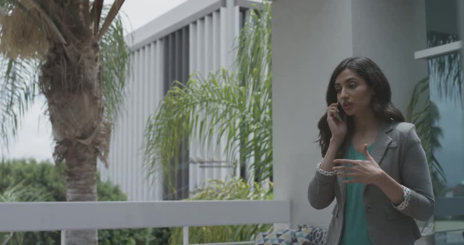 A woman talking on a phone walking around