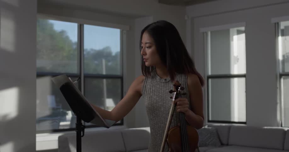 A woman writing on sheet music
