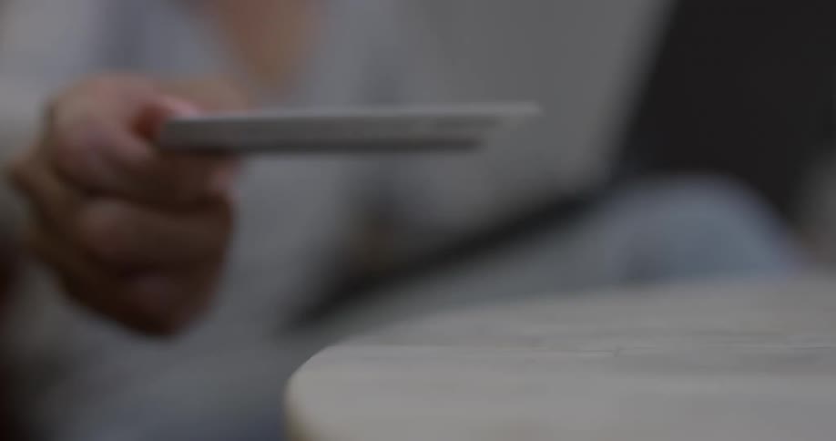 Person picks up a credit card from a table