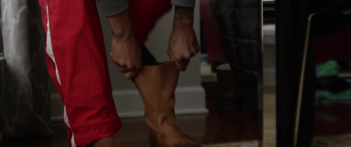 Someone is putting their boots on