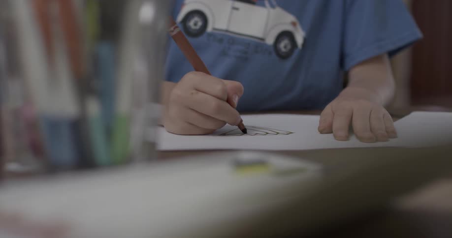 Child sketches on paper