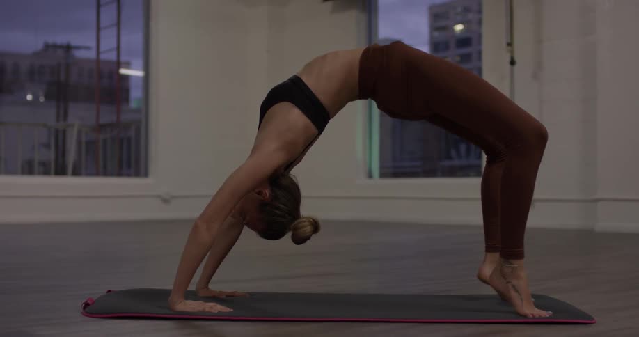Woman Doing Yoga In Empty Building