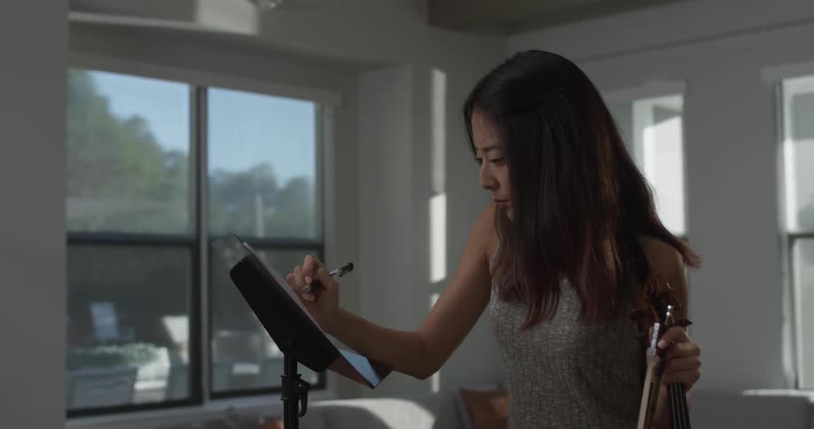 A woman is writing on paper