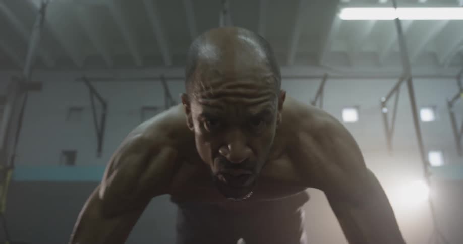 A man has his feet in exercise straps