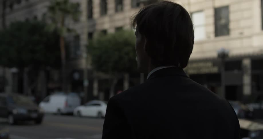 A man is walking outside in the city