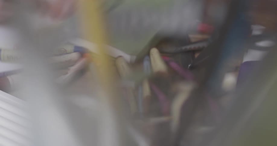 Someone picks up crayons and draws with them