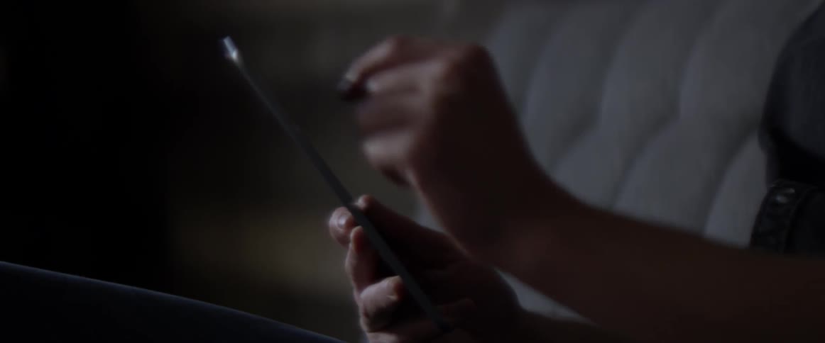 A man working on a phone on a couch