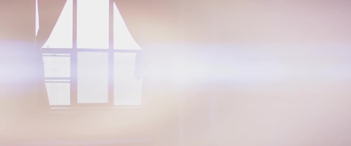 Man stands in a living room talking on the phone