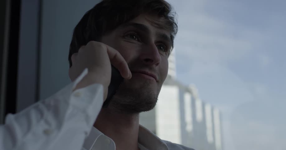A man answers his phone and begins having a conversation