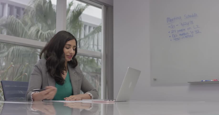 A woman typing something on her laptop at work
