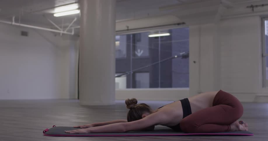 Woman Doing Yoga In Empty Building