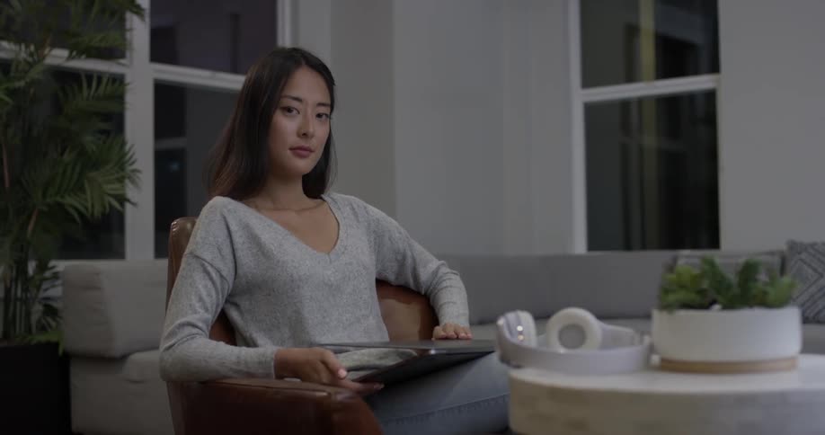 Woman types on a laptop in a living room