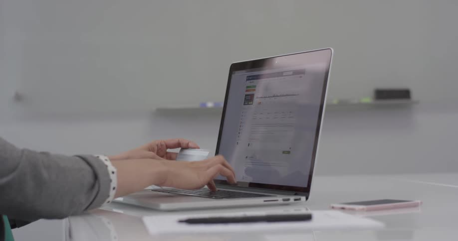 Woman entering a credit card on a laptop