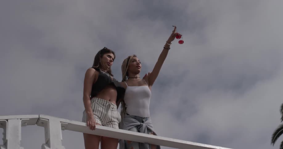 Two women looking of a balcony