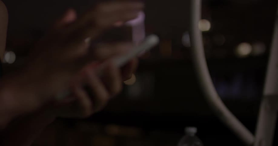 Closeup of a woman's hands working on a smartphone