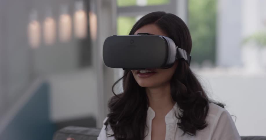 A woman is playing a virtual reality system in a house