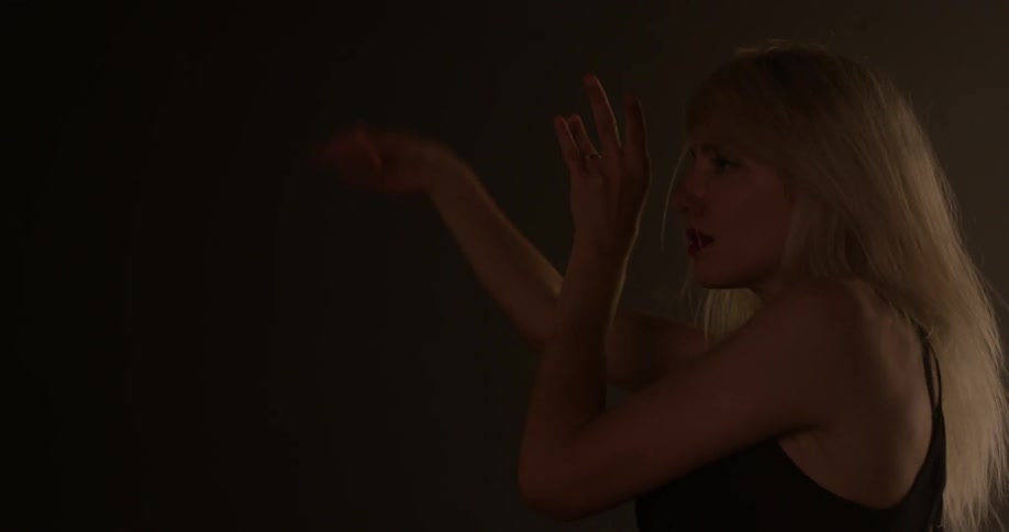 Woman dances and waves her hair around