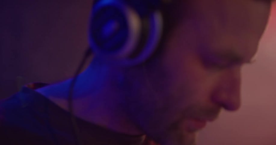 Dj puts headphones on in club