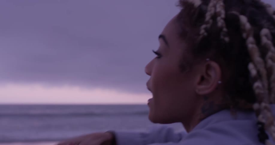 Woman sits on the beach talking
