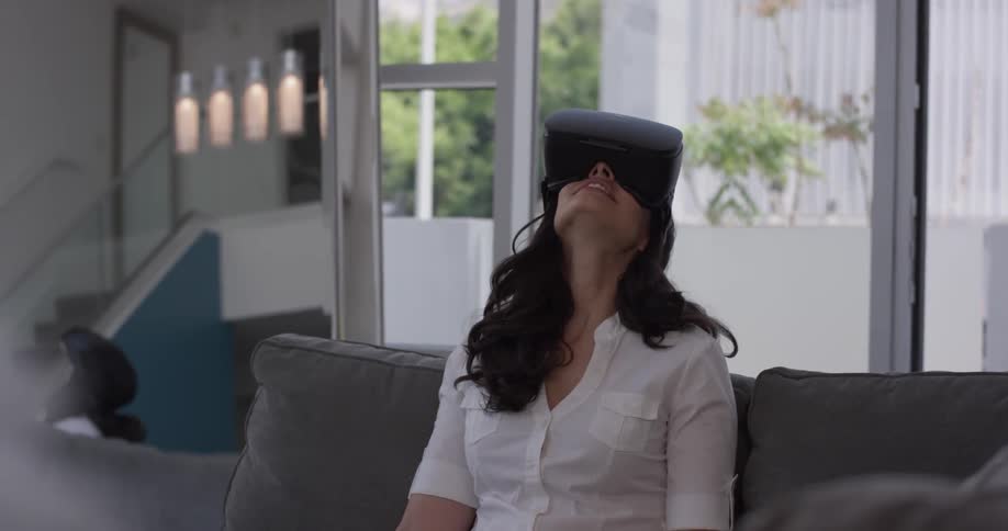 Woman sits on the couch looking through a virtual machine