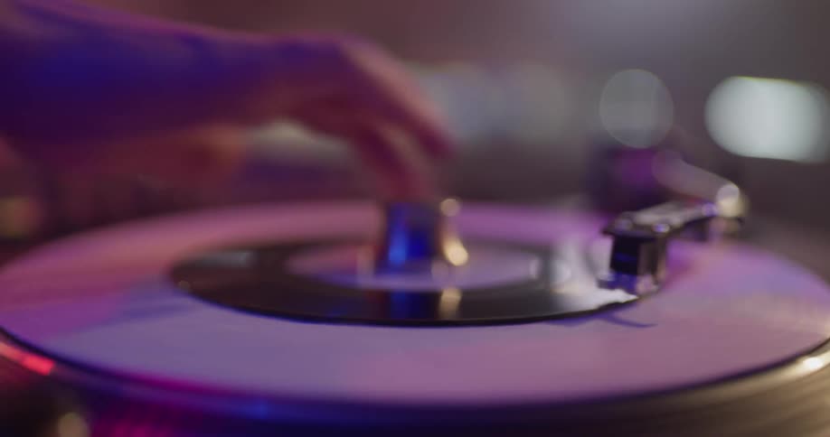 A person is putting records on