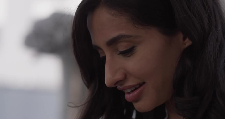 A woman is taking off a virtual reality headset and admiring it afterwards
