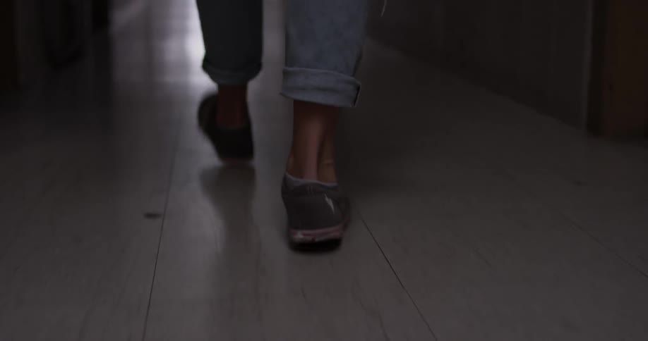 A person walking down a tile hallway