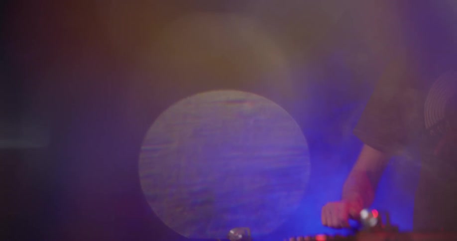 A man is getting ready to play music at a venue