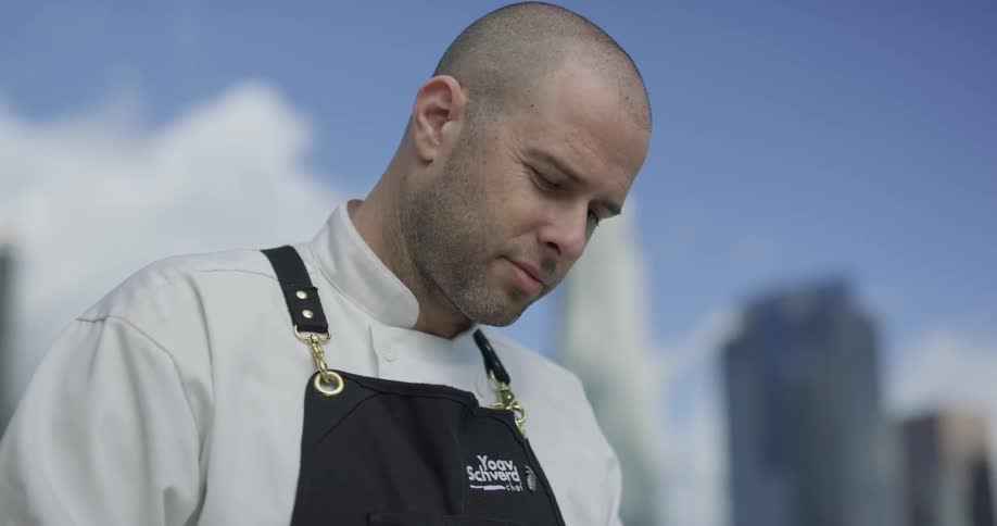 Man wearing an apron standing outside