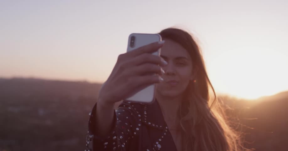 A woman using her cell phone to take a selfie