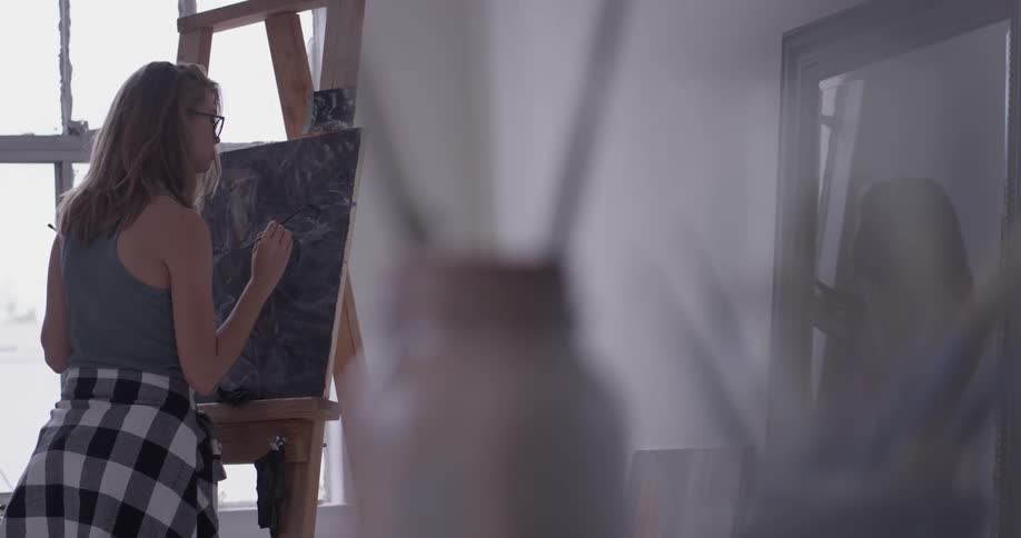 A woman painting on a canvas