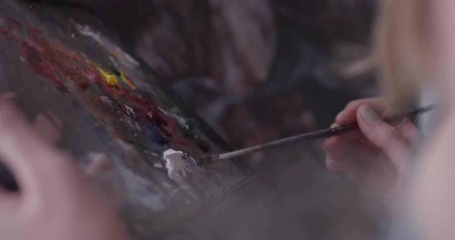 A person painting in a studio