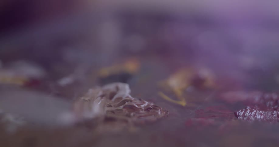 A person that is painting with a knife