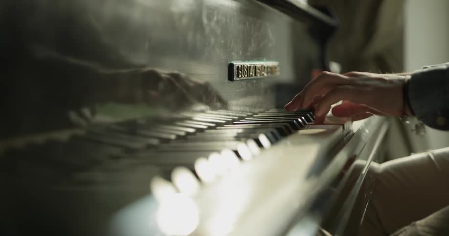 Person's hands playing piano