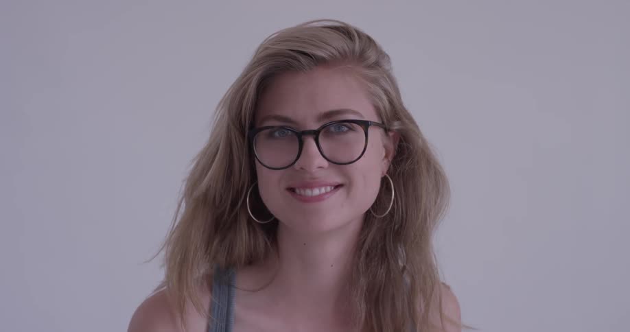A woman with dirty blonde hair and glasses smiles warmly