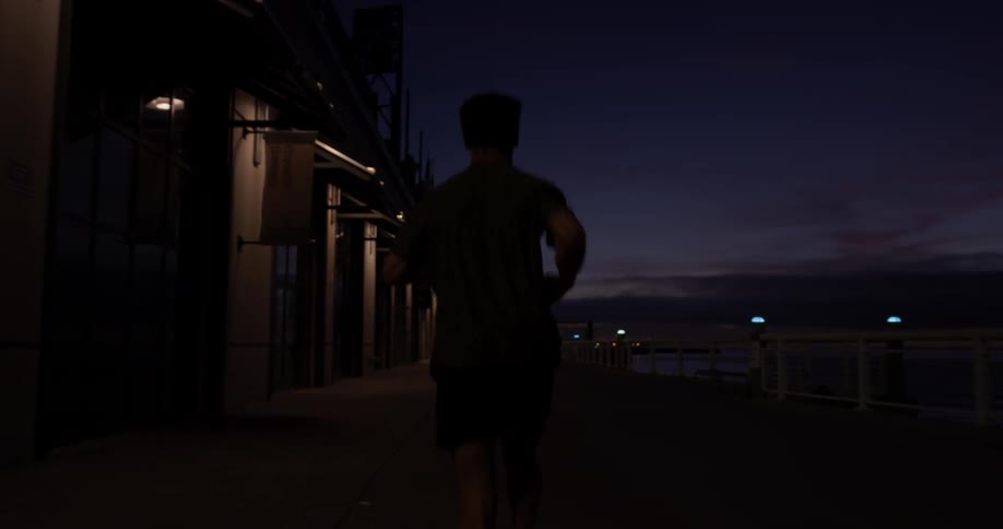 A man running in a city at night