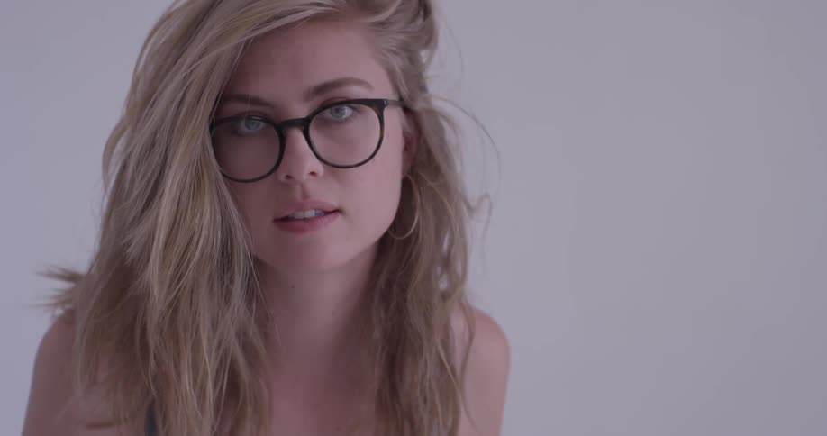 Girl with big glasses looks into camera