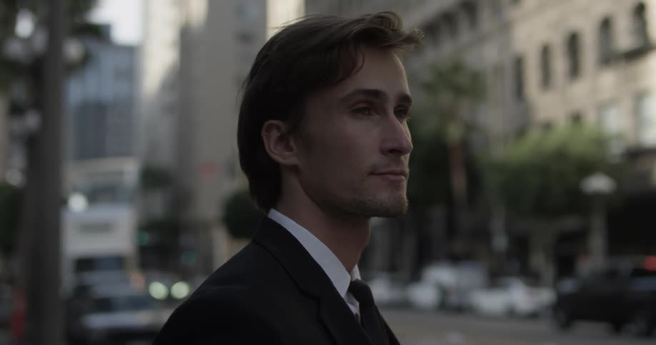 A man is overlooking the street while cars pass by