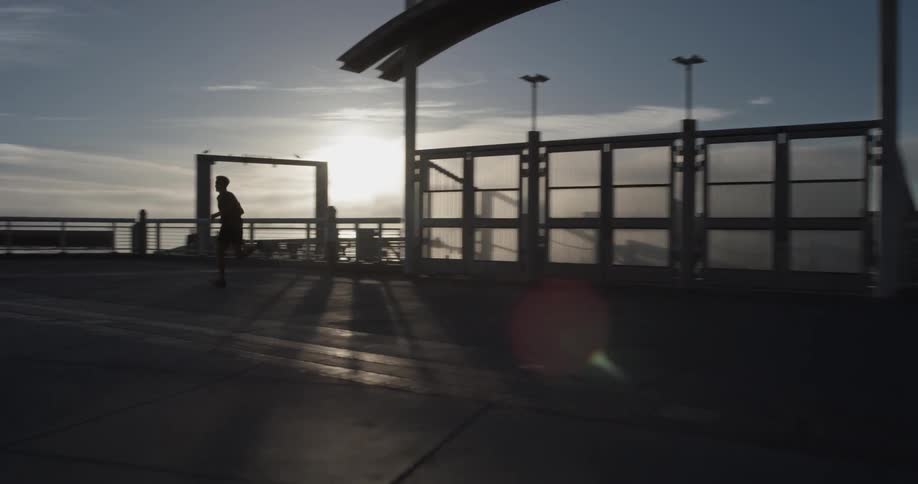 A person running along the edge of the ocean