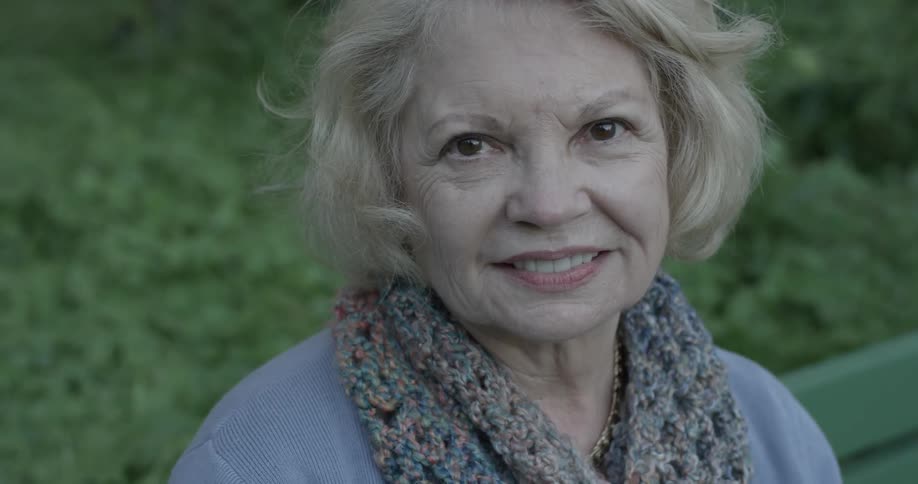 Elderly woman looks around and smiles