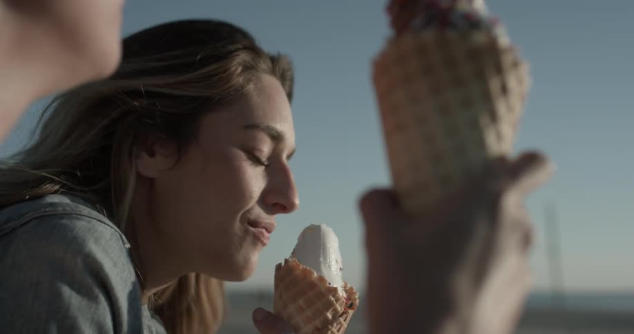 Girl is eating ice cream with someone