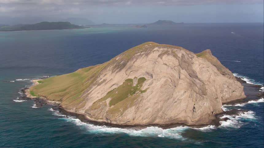 Aerial shot of a hill island in an ocean