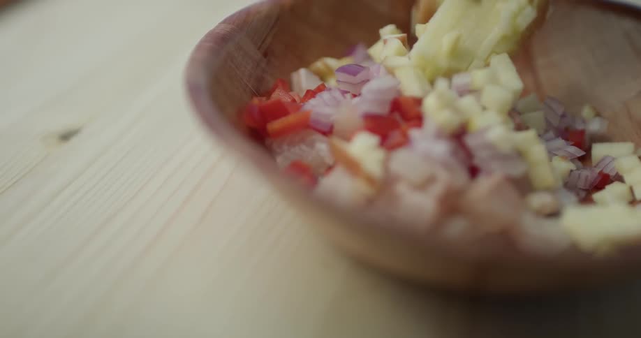 A person is putting ingredients into a bowl
