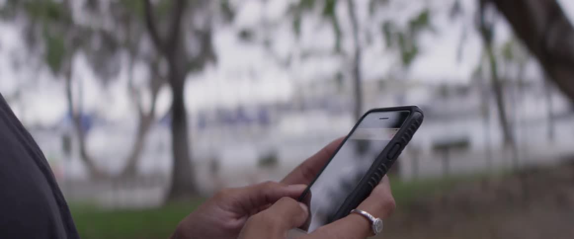 A woman scrolling on a cell phone