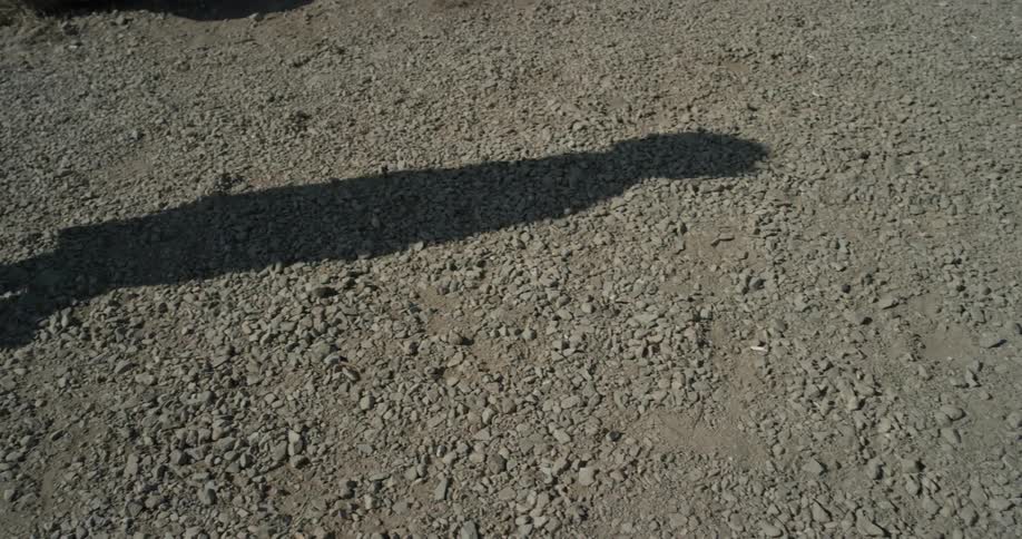 Shadow of a person on a stone ground