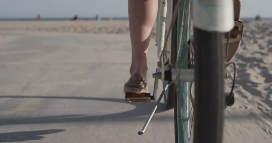 A person riding a bicycle by the beach