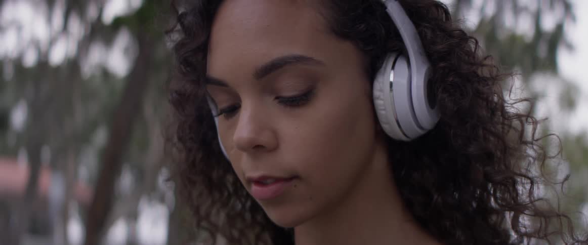 A woman listens to music