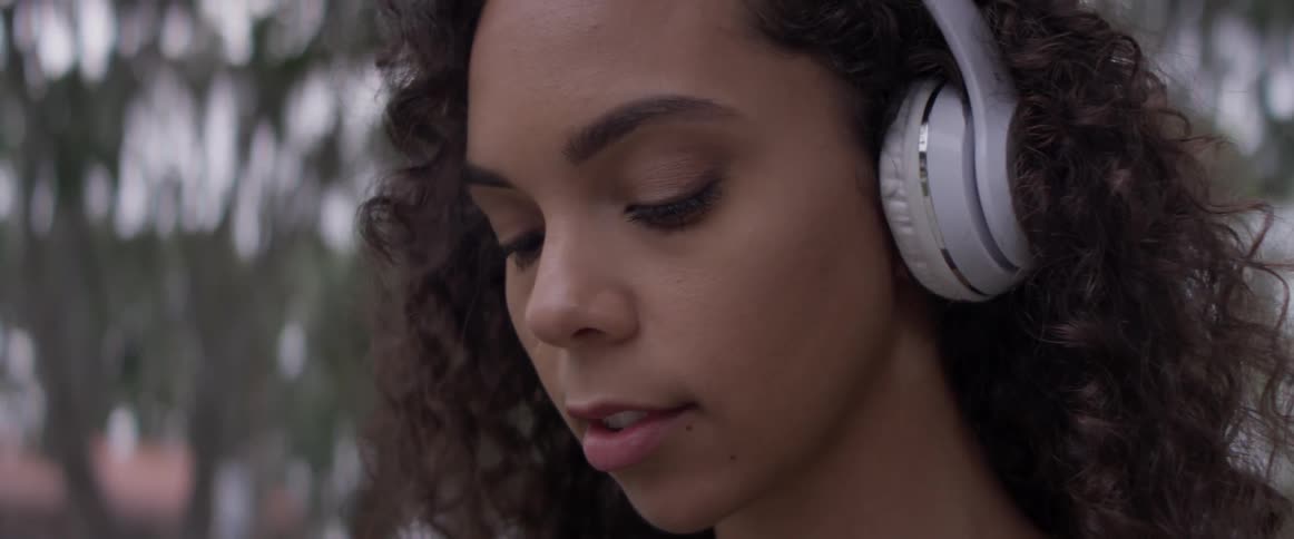 Woman listening to music on headphones outside